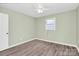 An updated bedroom with neutral paint, ceiling fan and hardwood floors awaits new owners at 333 S Eastway Dr, Troutman, NC 28166