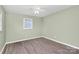 Cozy bedroom featuring new floors, fresh paint, and natural light from a window at 333 S Eastway Dr, Troutman, NC 28166
