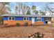 Charming home with a blue exterior, red brick, screened in porch, and spacious front yard at 333 S Eastway Dr, Troutman, NC 28166
