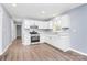 Bright kitchen with white cabinets, stainless steel appliances, luxury vinyl floors, and neutral walls at 333 S Eastway Dr, Troutman, NC 28166