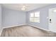 Bright living room with luxury vinyl flooring, neutral walls, new ceiling fan, and abundant natural light at 333 S Eastway Dr, Troutman, NC 28166