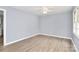 Bright living room with luxury vinyl flooring, neutral walls, new ceiling fan, and abundant natural light at 333 S Eastway Dr, Troutman, NC 28166