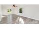 Bright bedroom featuring light gray vinyl floors, neutral walls, two windows, and a ceiling fan for comfort at 341 Cline Dr, Salisbury, NC 28146