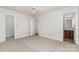 Spacious bedroom featuring neutral carpet, ceiling fan, and adjacent bathroom at 341 Cline Dr, Salisbury, NC 28146