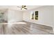 Light-filled bedroom with modern light gray vinyl floors, neutral paint, and a ceiling fan for added comfort at 341 Cline Dr, Salisbury, NC 28146