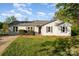 Charming single-story home featuring a well-maintained lawn, gray siding, and dark shutters under a bright blue sky at 341 Cline Dr, Salisbury, NC 28146