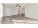Bright living room featuring modern light gray vinyl floors, neutral paint, and a ceiling fan for added comfort at 341 Cline Dr, Salisbury, NC 28146