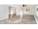 Open concept living area featuring light gray vinyl floors, neutral paint, ample natural light, and a modern ceiling fan at 341 Cline Dr, Salisbury, NC 28146
