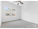 Bright bedroom with a large window, neutral carpet, and a ceiling fan at 3808 Odom Way, Charlotte, NC 28216