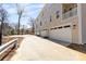 View of the garage doors of the townhome property with a paved driveway in front at 3808 Odom Way, Charlotte, NC 28216