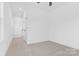 Spacious hallway with neutral walls, carpet flooring, and a window allowing natural light at 3808 Odom Way, Charlotte, NC 28216