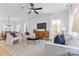 Open-concept living room with natural light, stylish furnishings, and seamlessly connected dining area at 3808 Odom Way, Charlotte, NC 28216