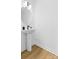 This powder room showcases a pedestal sink with modern faucet and a round mirror at 3808 Odom Way, Charlotte, NC 28216
