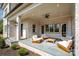 A comfortable covered patio with white-painted brick pillars, a ceiling fan, and outdoor furniture at 4004 Nettie Ct # 1, Charlotte, NC 28211
