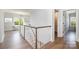 Upstairs hallway featuring hardwood floors, white trim, and a view into a sitting room at 4004 Nettie Ct # 1, Charlotte, NC 28211