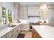 Well-lit kitchen showcases stainless steel appliances, gray cabinets, and marble countertops at 4004 Nettie Ct # 1, Charlotte, NC 28211