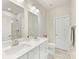 Bright bathroom with double sinks, modern fixtures, and a glass-enclosed shower at 4010 Citra Ln, Charlotte, NC 28217