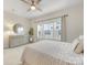 Serene bedroom featuring a ceiling fan, dresser, and large window providing ample natural light at 4010 Citra Ln, Charlotte, NC 28217