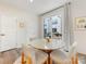 Bright dining room with a modern round table, seating four, and sliding doors to a private balcony at 4010 Citra Ln, Charlotte, NC 28217