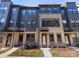 Modern townhome with brick and dark siding, large windows, and well-maintained landscaping at 4010 Citra Ln, Charlotte, NC 28217