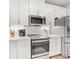 Contemporary kitchen featuring stainless steel appliances, white cabinets, and a modern design at 4010 Citra Ln, Charlotte, NC 28217