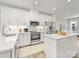 Modern kitchen features white cabinets, quartz countertops, stainless steel appliances, and an island at 4010 Citra Ln, Charlotte, NC 28217