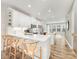 Open concept kitchen with white cabinetry, stainless appliances, and an island with bar seating at 4010 Citra Ln, Charlotte, NC 28217