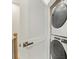 Convenient laundry room with stacked washer and dryer, easily accessible near the stairs at 4010 Citra Ln, Charlotte, NC 28217