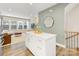 Open-concept living space featuring an island, staircase and a large window providing natural light at 4010 Citra Ln, Charlotte, NC 28217