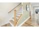 Modern staircase with light wood railings and a decorative mirror at 4010 Citra Ln, Charlotte, NC 28217
