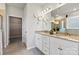 Bright bathroom featuring double vanity, granite countertop, decorative wall art and walk-in closet at 4023 Vista Pine Dr, Charlotte, NC 28215