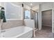 Bathroom featuring soaking tub, glass shower and large window providing natural light at 4023 Vista Pine Dr, Charlotte, NC 28215