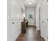 Bright hallway with dark laminate flooring and access to multiple rooms at 4023 Vista Pine Dr, Charlotte, NC 28215