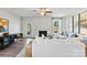 Bright living room with a fireplace, ceiling fan, and views of the backyard at 4023 Vista Pine Dr, Charlotte, NC 28215