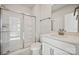 Modern bathroom with a glass-enclosed shower, white vanity, and marble tile flooring at 4027 Vista Pine Dr, Charlotte, NC 28215