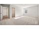 Spacious bedroom with carpet, walk-in closet, and bright light at 4027 Vista Pine Dr, Charlotte, NC 28215