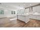 Open-concept kitchen featuring a large island, stainless steel appliances, and hardwood floors at 4027 Vista Pine Dr, Charlotte, NC 28215