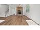 Spacious living room featuring a stone fireplace, a ceiling fan and hardwood floors at 4027 Vista Pine Dr, Charlotte, NC 28215