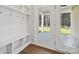 Bright and airy mud room featuring plenty of hooks and storage with access to the back porch at 4027 Vista Pine Dr, Charlotte, NC 28215