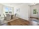 Bright dining room with modern lighting, white table and chairs, and a view of the front yard at 4035 Vista Pine Dr, Charlotte, NC 28215