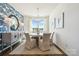 Bright dining room with stylish wallpaper, modern lighting, and a view of the front yard at 4035 Vista Pine Dr, Charlotte, NC 28215