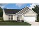 Charming single-story home featuring stone accents, neutral siding, and an attached two-car garage at 4035 Vista Pine Dr, Charlotte, NC 28215