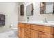 Bathroom featuring double vanity, wood cabinets, and modern fixtures at 404 N Laurel Ave # 18, Charlotte, NC 28204