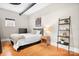 Comfortable bedroom with wooden floors, natural light and tasteful furnishings at 404 N Laurel Ave # 18, Charlotte, NC 28204