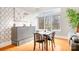 Bright dining area with hardwood floors, a modern accent wall, and large window offering natural light at 404 N Laurel Ave # 18, Charlotte, NC 28204