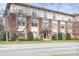 Brick apartment building featuring manicured landscaping and mature trees, nestled on a well-maintained city street at 404 N Laurel Ave # 18, Charlotte, NC 28204