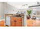 Modern kitchen featuring a breakfast bar, stainless steel dishwasher, and open layout into the living area at 404 N Laurel Ave # 18, Charlotte, NC 28204