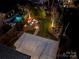 Aerial view of a backyard featuring a pool, fire pit, and landscaped areas at 448 Iverson Way, Charlotte, NC 28203