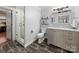 Bright bathroom with a glass-enclosed shower and vanity with elegant countertops at 448 Iverson Way, Charlotte, NC 28203