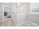 Bathroom featuring glass enclosed shower and an open doorway to the light-filled main bedroom at 448 Iverson Way, Charlotte, NC 28203